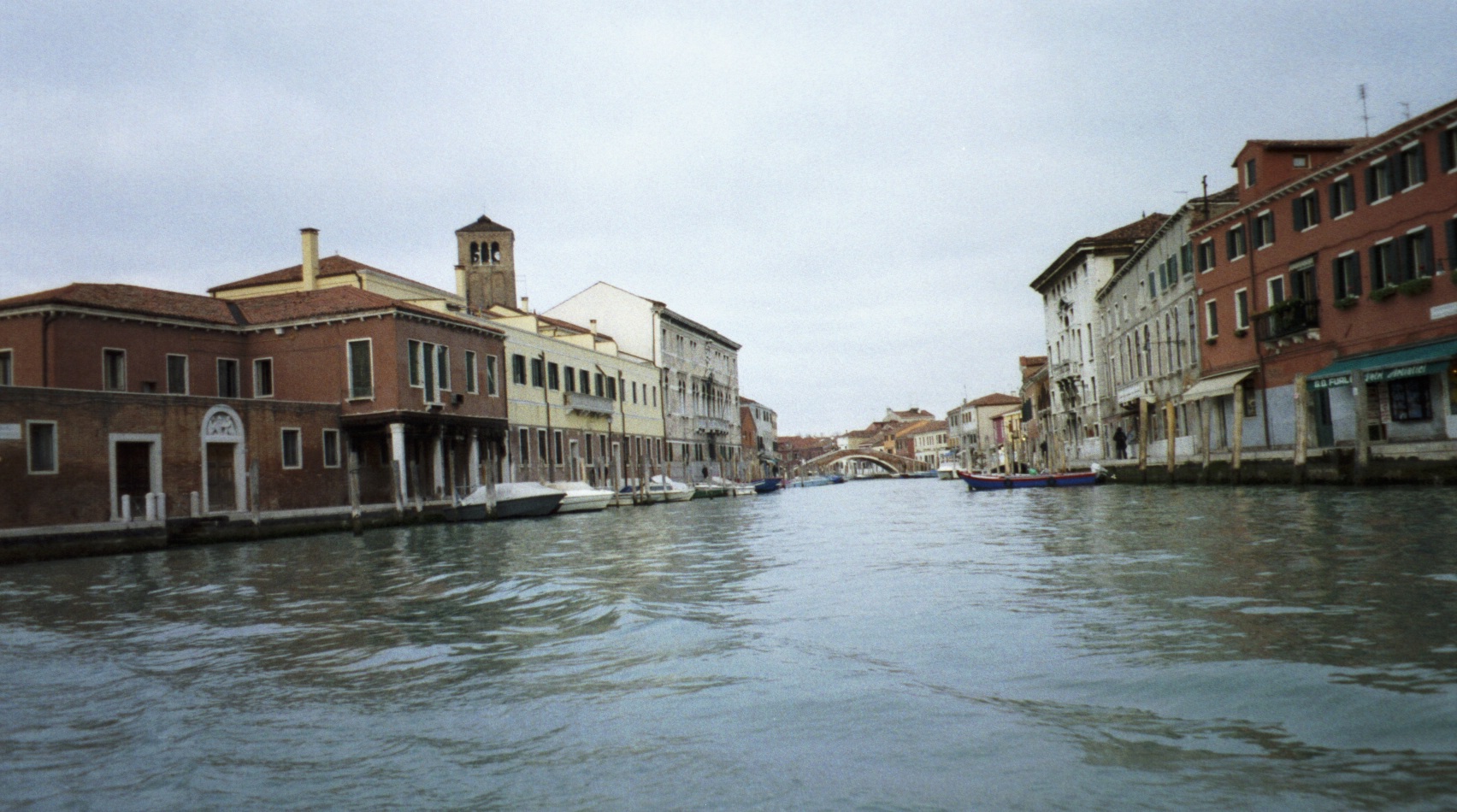 a large long canal has buildings on both sides