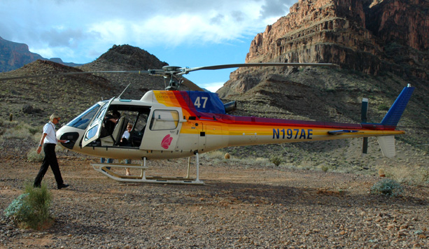 the helicopter is near a rocky area with people entering