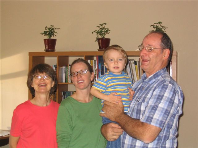 a family poses for a picture in the living room