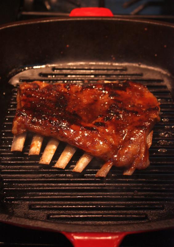 a piece of meat being grilled on a grill