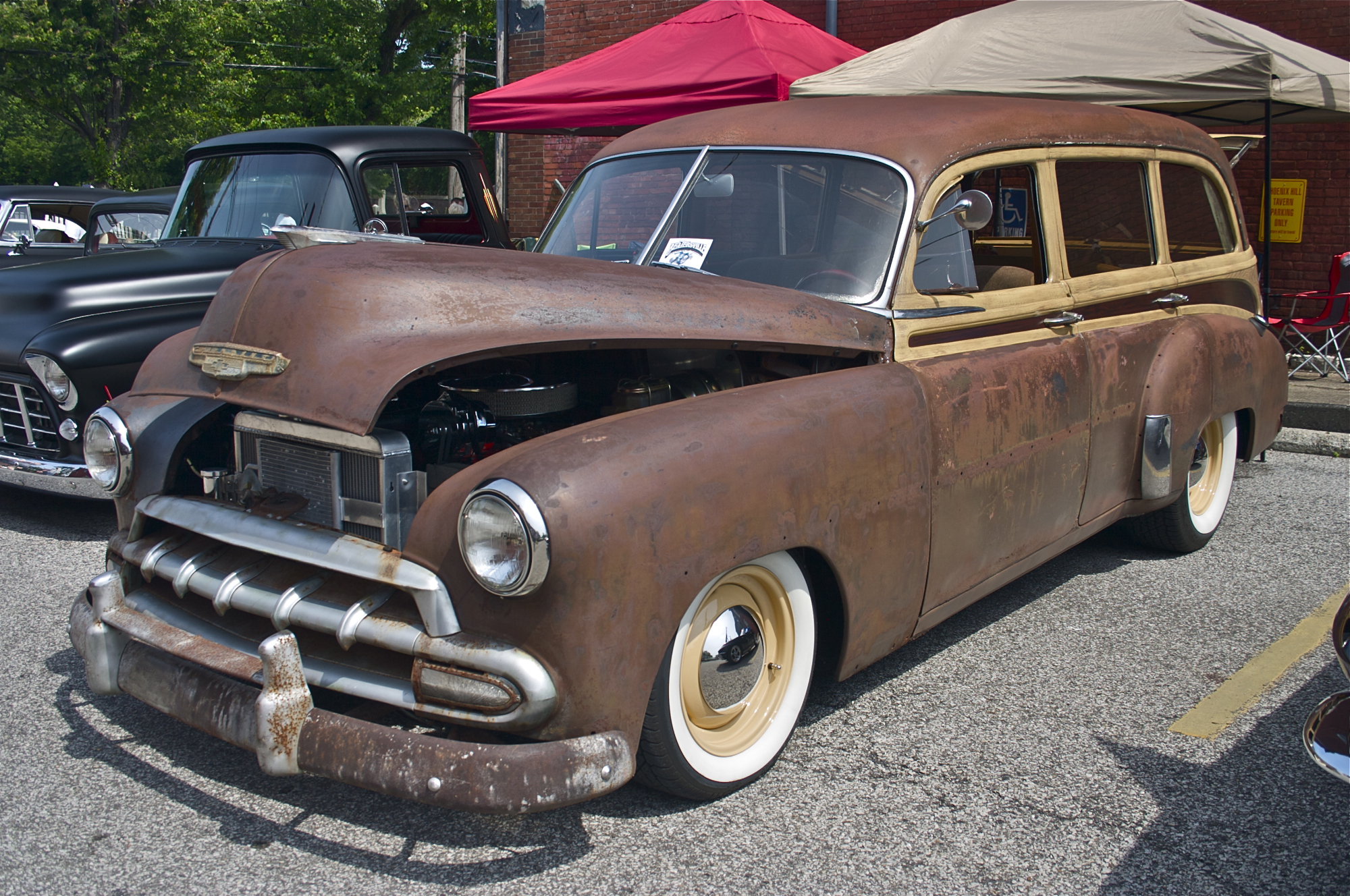 an old brown truck sitting on the pavement