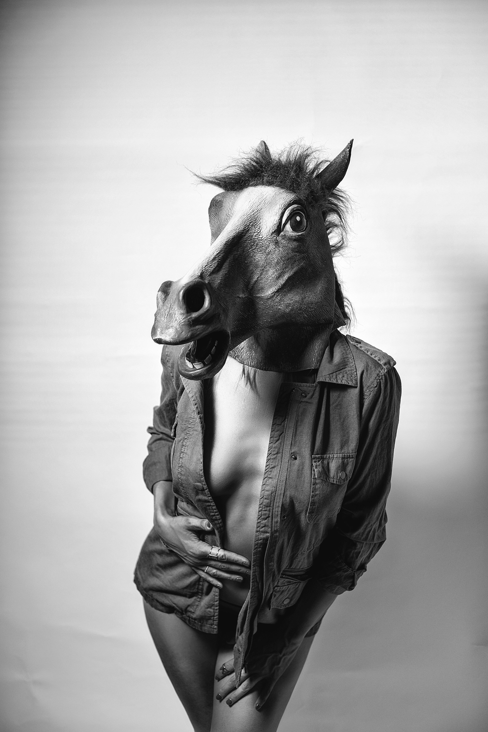 a man wearing a horse mask and clothes