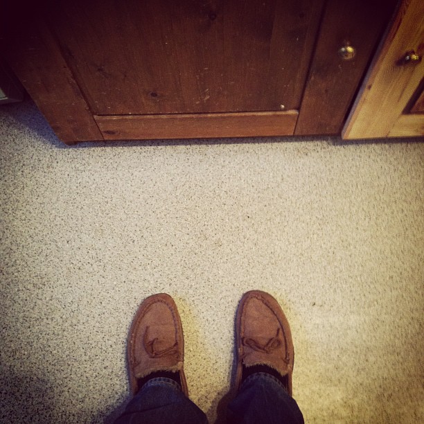 a person in brown shoes standing on a floor
