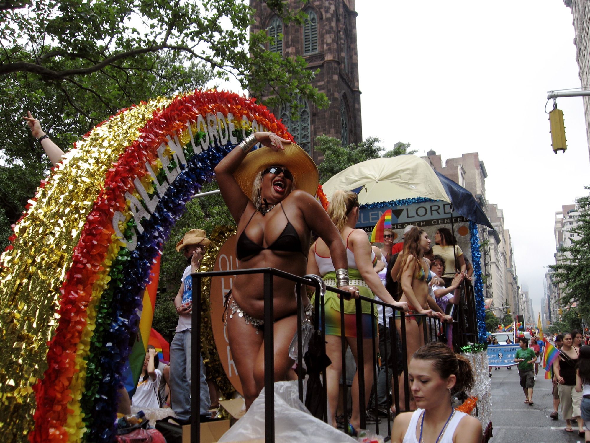 people on a city street parade in bathing suits