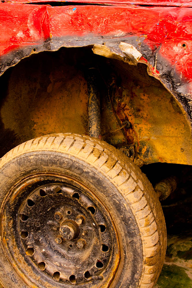 a rusted truck with a metal hub is seen under the tire