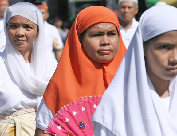 several women are dressed in similar ethnic attire