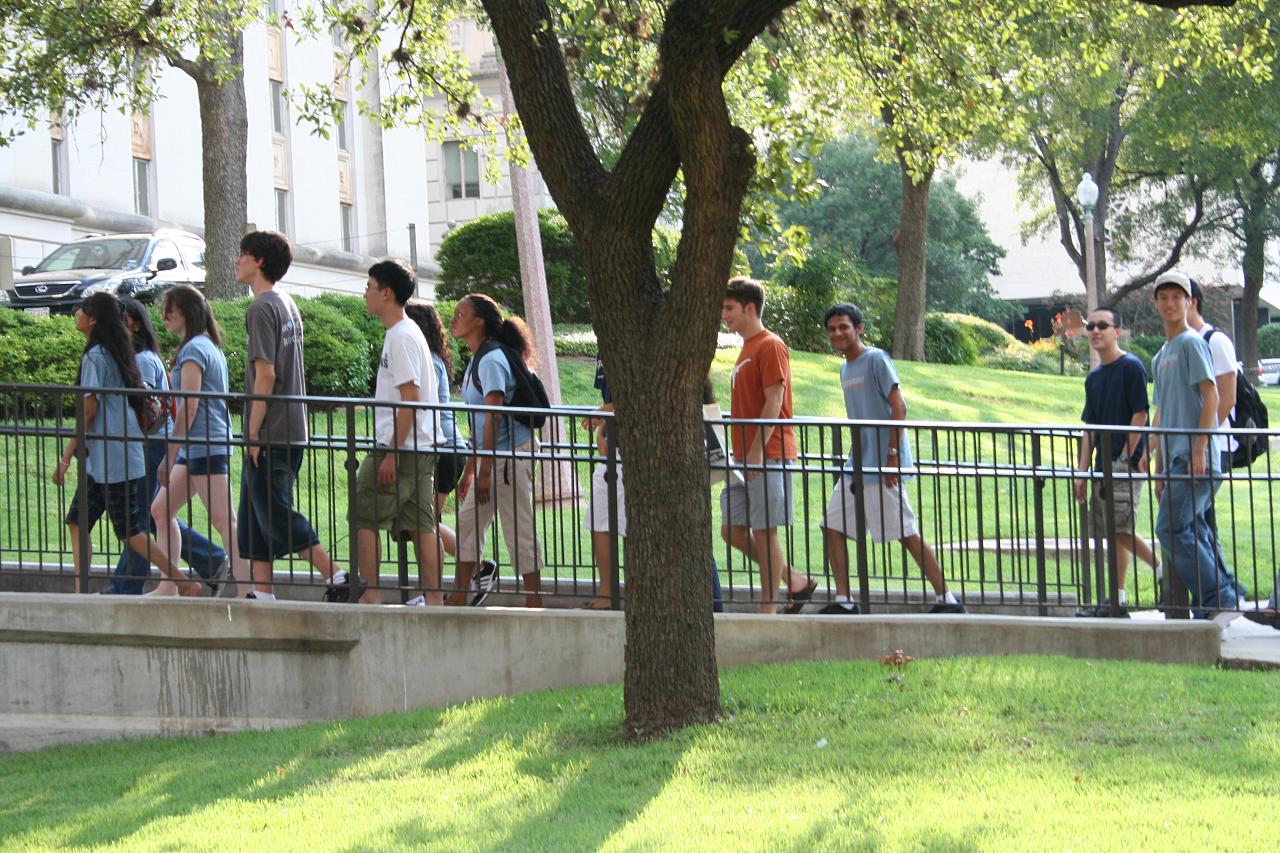 group of people walking on steps in a park