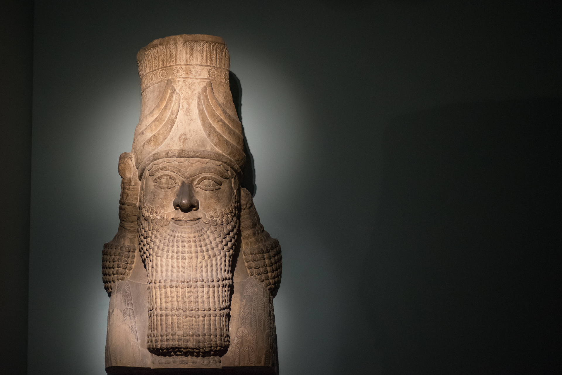a stone statue of an egyptian god with a horned head