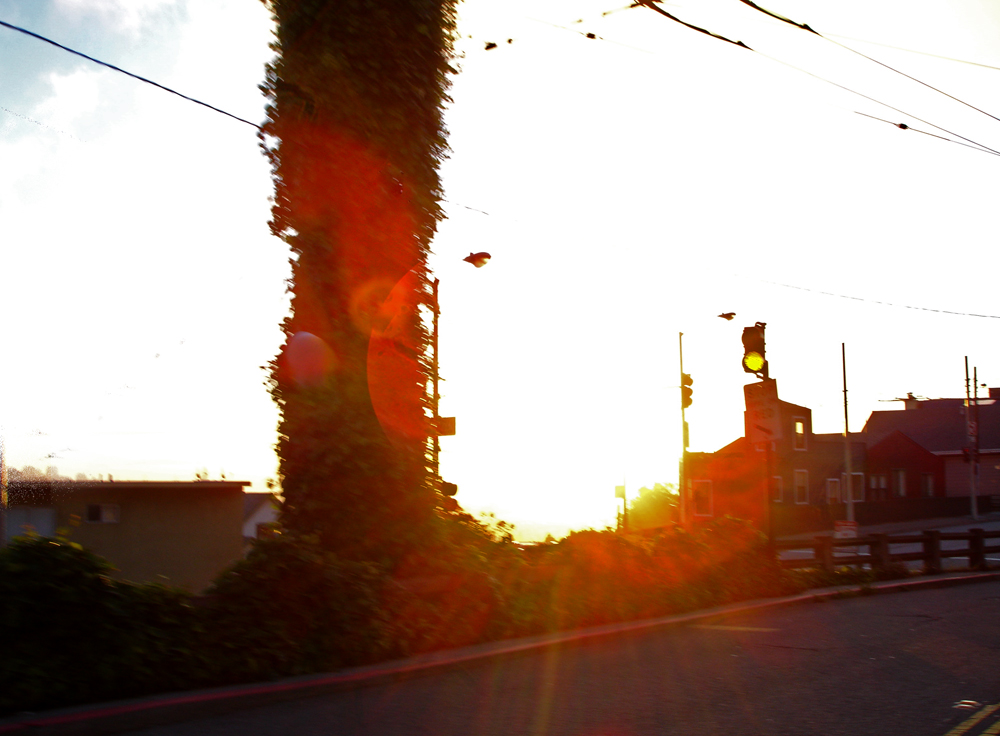 an intersection has two traffic lights in the background