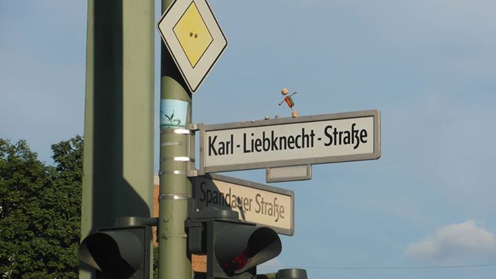 a traffic light with street signs and directional lights on it
