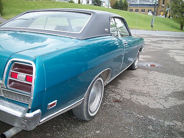 a classic american car in a parking lot