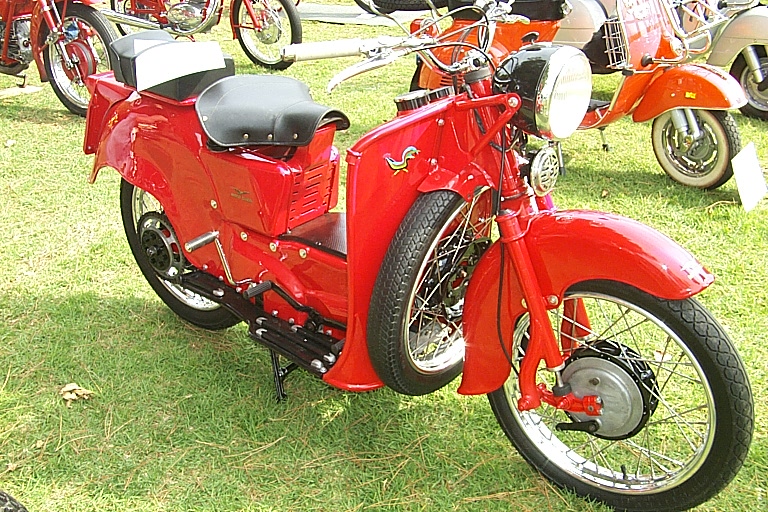 a close up of a motorcycle parked on grass