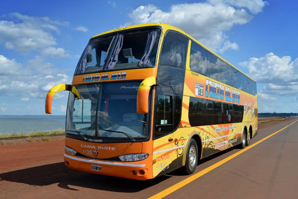 a large bus drives down the road