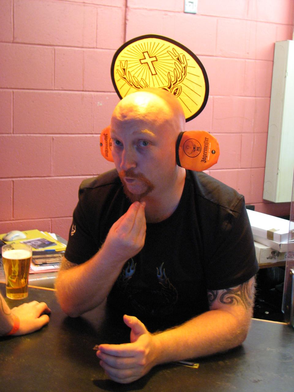 a man is sitting at the bar with some beer