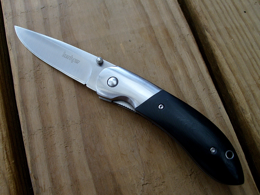 a kitchen knife that is on the surface