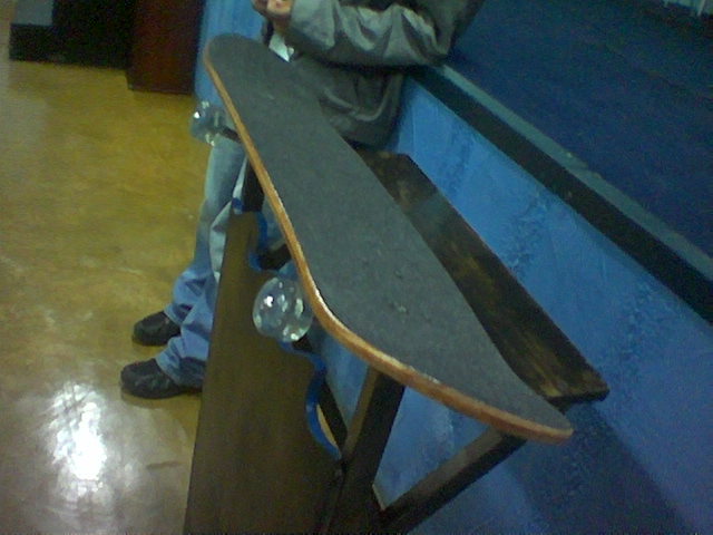 a person leaning on a bench with a skateboard
