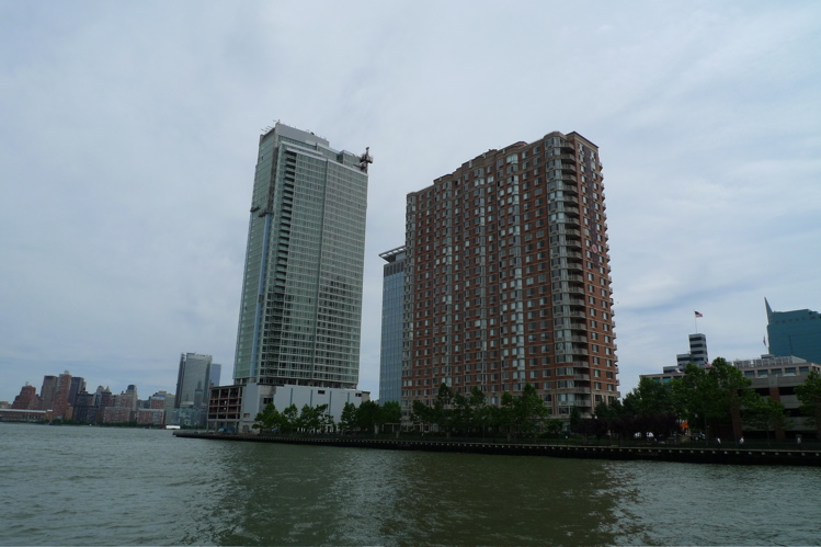 a large body of water with two tall buildings on one side