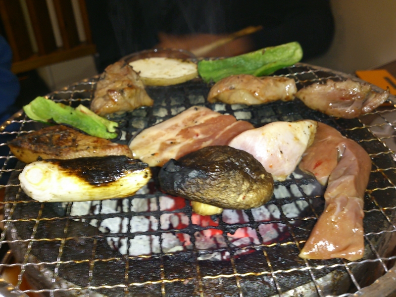 different types of meats on the grill ready to be cooked