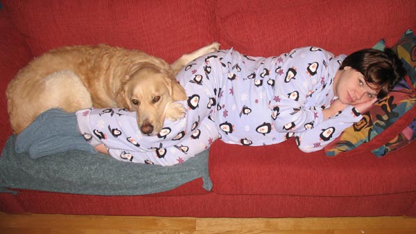 a dog laying next to a baby and a golden retriever