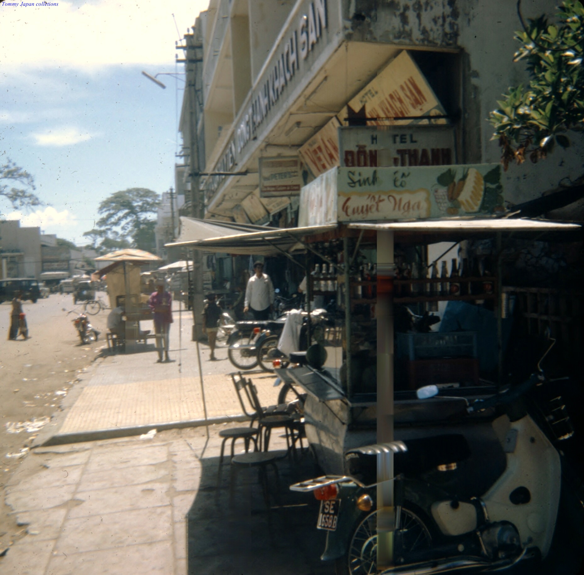 motorcycles parked on the side of a street near a food cart