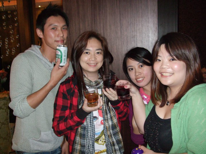 the group poses for a po while holding up two of their drinks