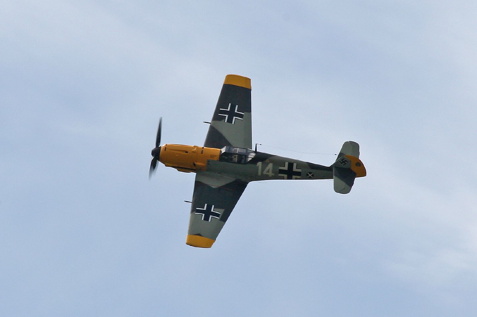 an older air plane flying through a cloudless sky