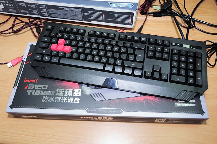 a computer keyboard with two red arrows attached to it