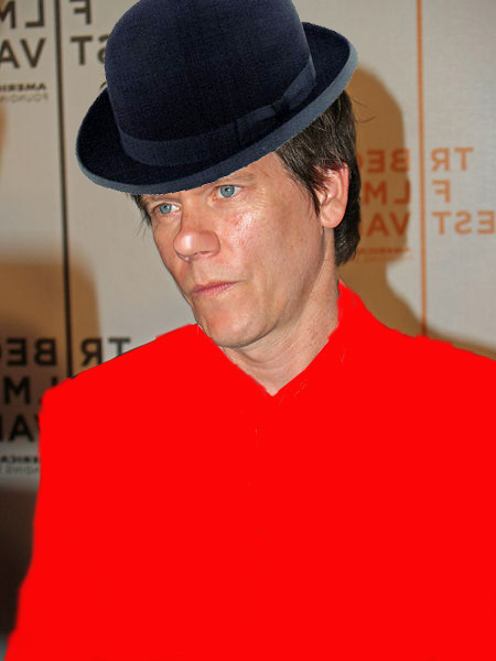 a man in a red top hat looking into the distance