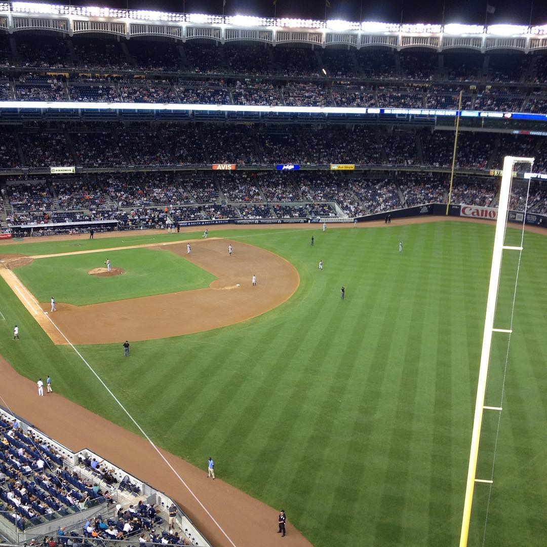 view of a baseball field from the upper deck at night