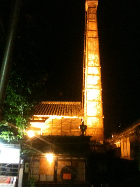 a tall tower lit up at night with lights on