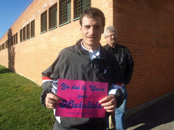 a man holding a sign for someone who is not on the side walk