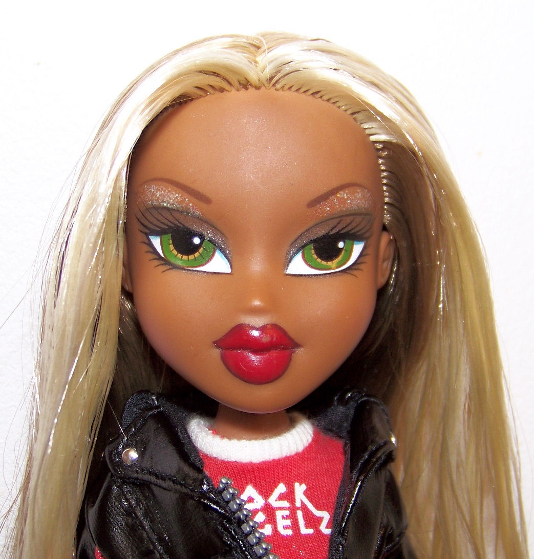 a dolls face with bright green eyes and a red lips