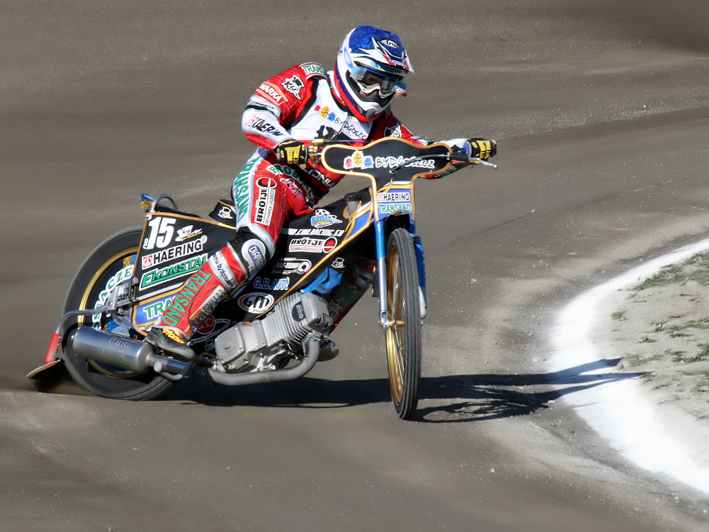 a man riding on the back of a motorcycle on a road