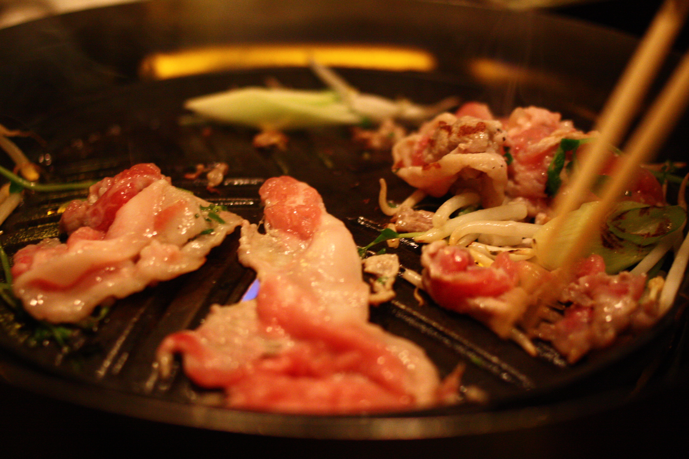 chinese meat and vegetables being cooked in a set