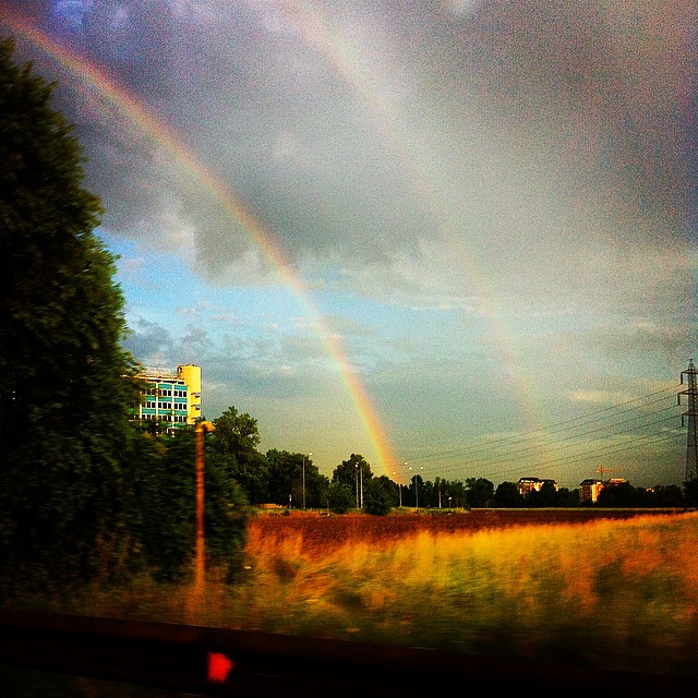 the view from the train window shows a rainbow