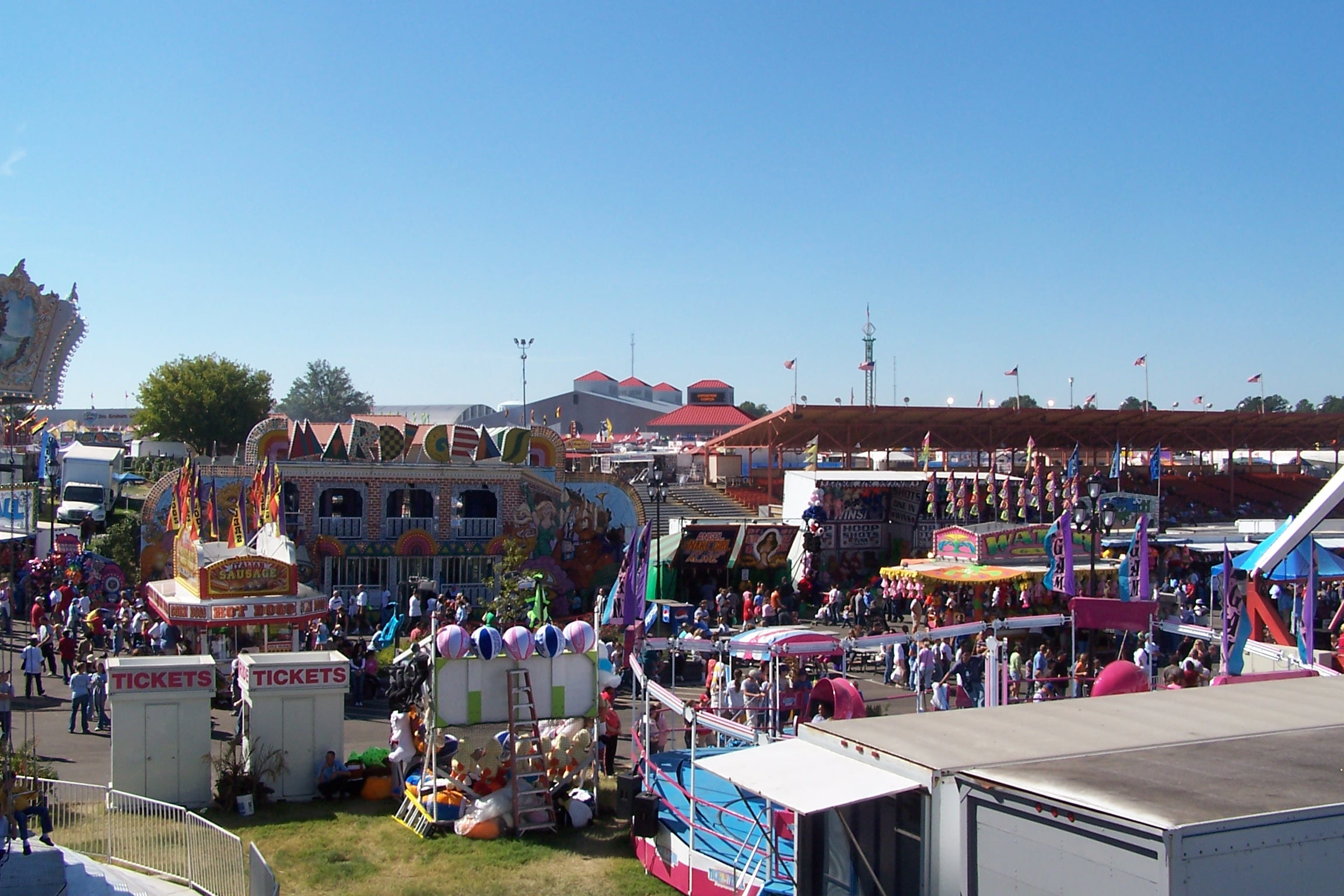 people standing in front of a carnival ride