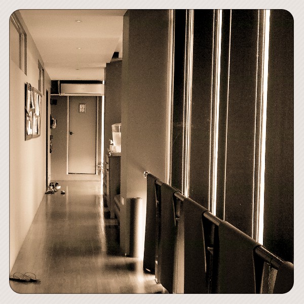 an empty hallway is lined with metal hand rails