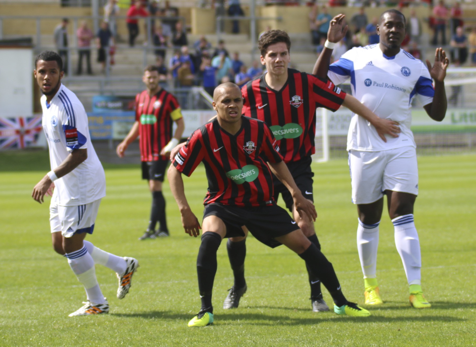 several boys playing soccer on a grass field