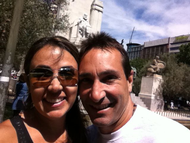 two people in front of a monument and a building