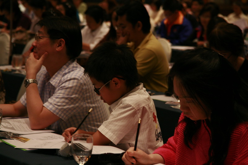 some people sitting at tables with some papers