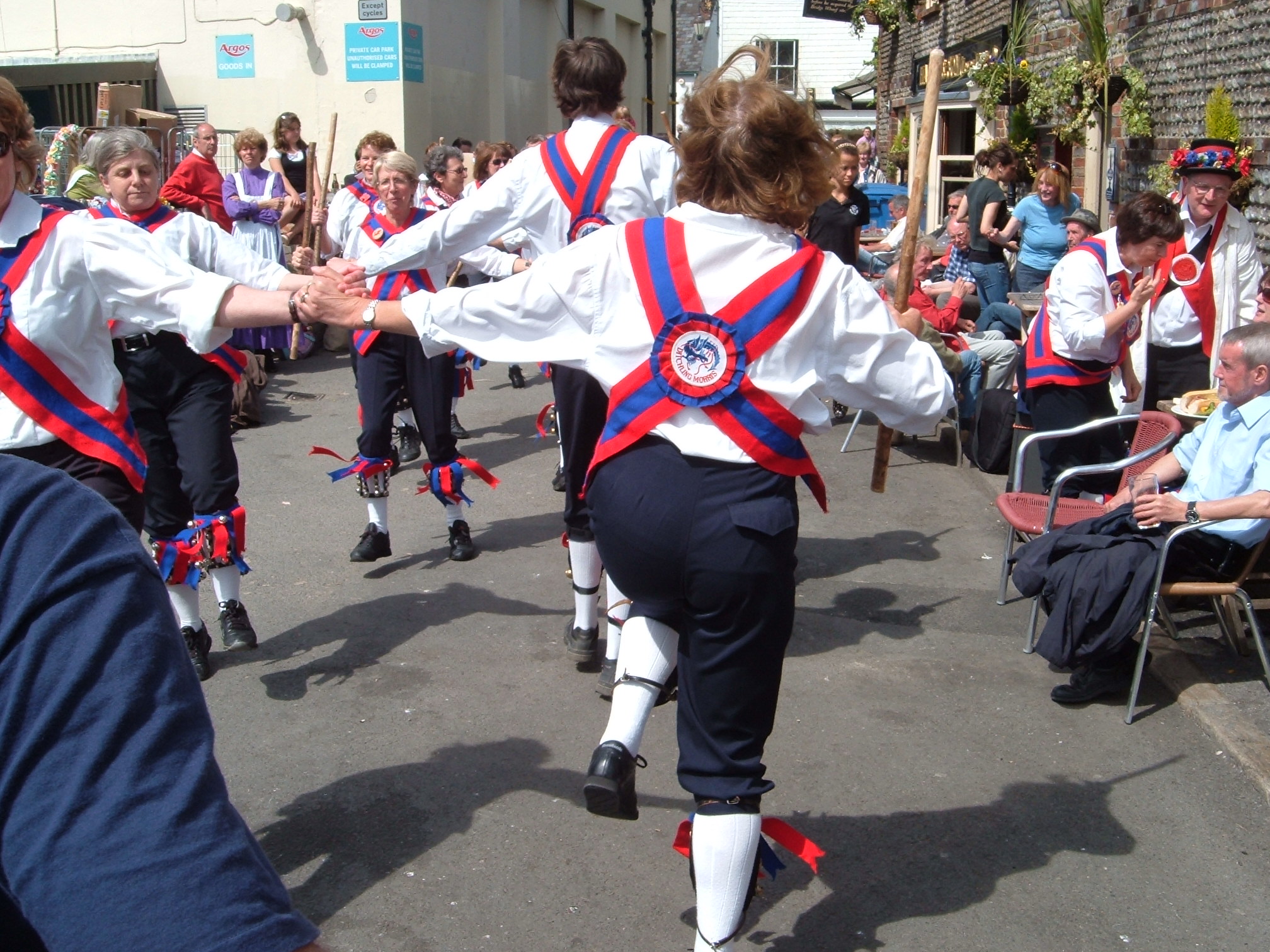 three people wearing red, white and blue uniforms dance in the street