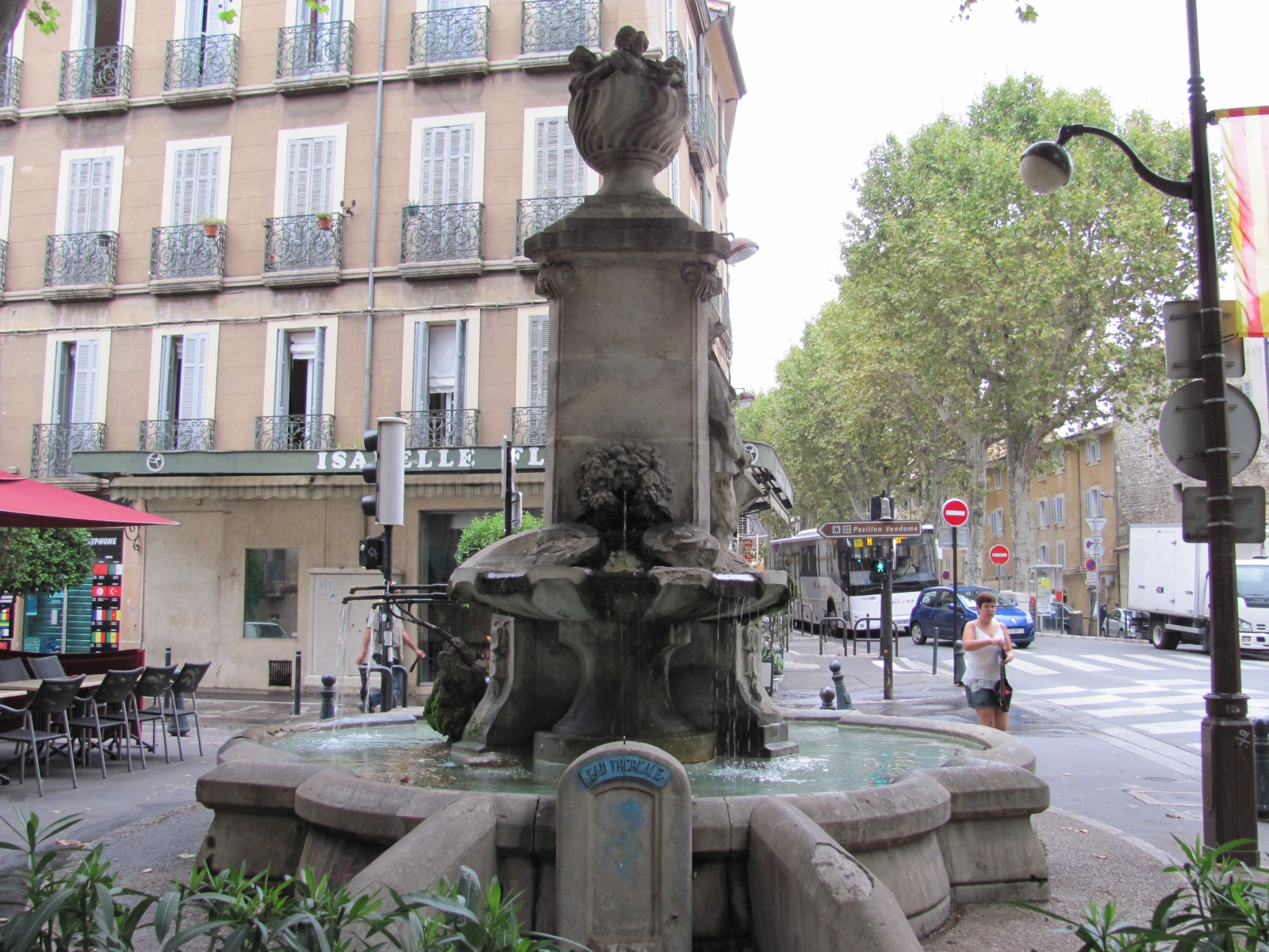 there is an old fountain on the corner of this street