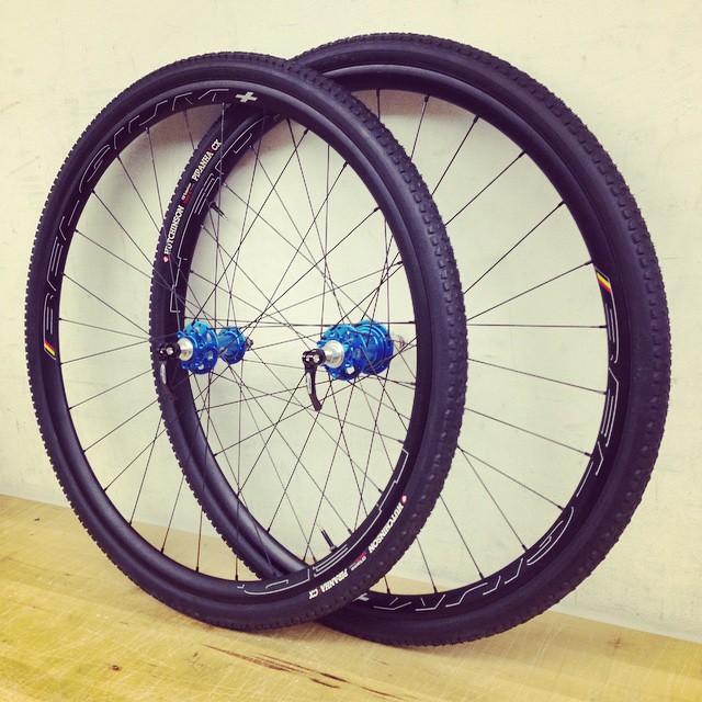 a close up view of two wheels with blue rims