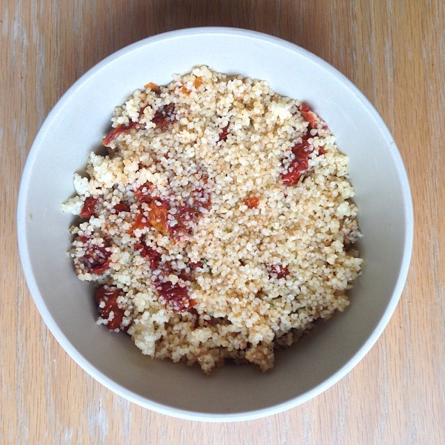 a white bowl filled with food sitting on top of a table