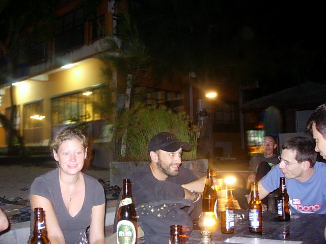 a group of people enjoying various beers at night