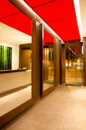 a hallway with a red ceiling and windows next to a bar