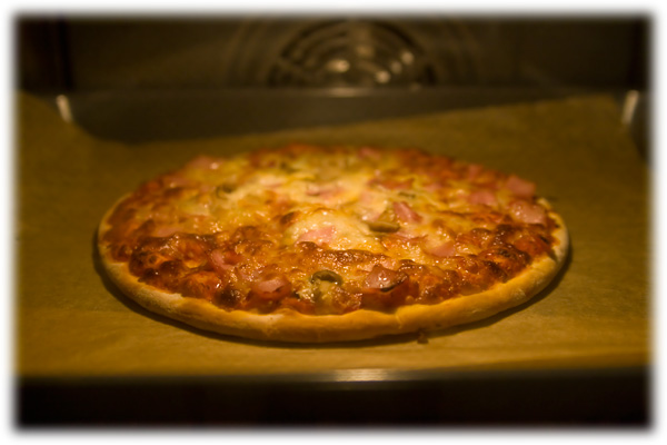 a baked pizza sitting on top of a metal oven pan