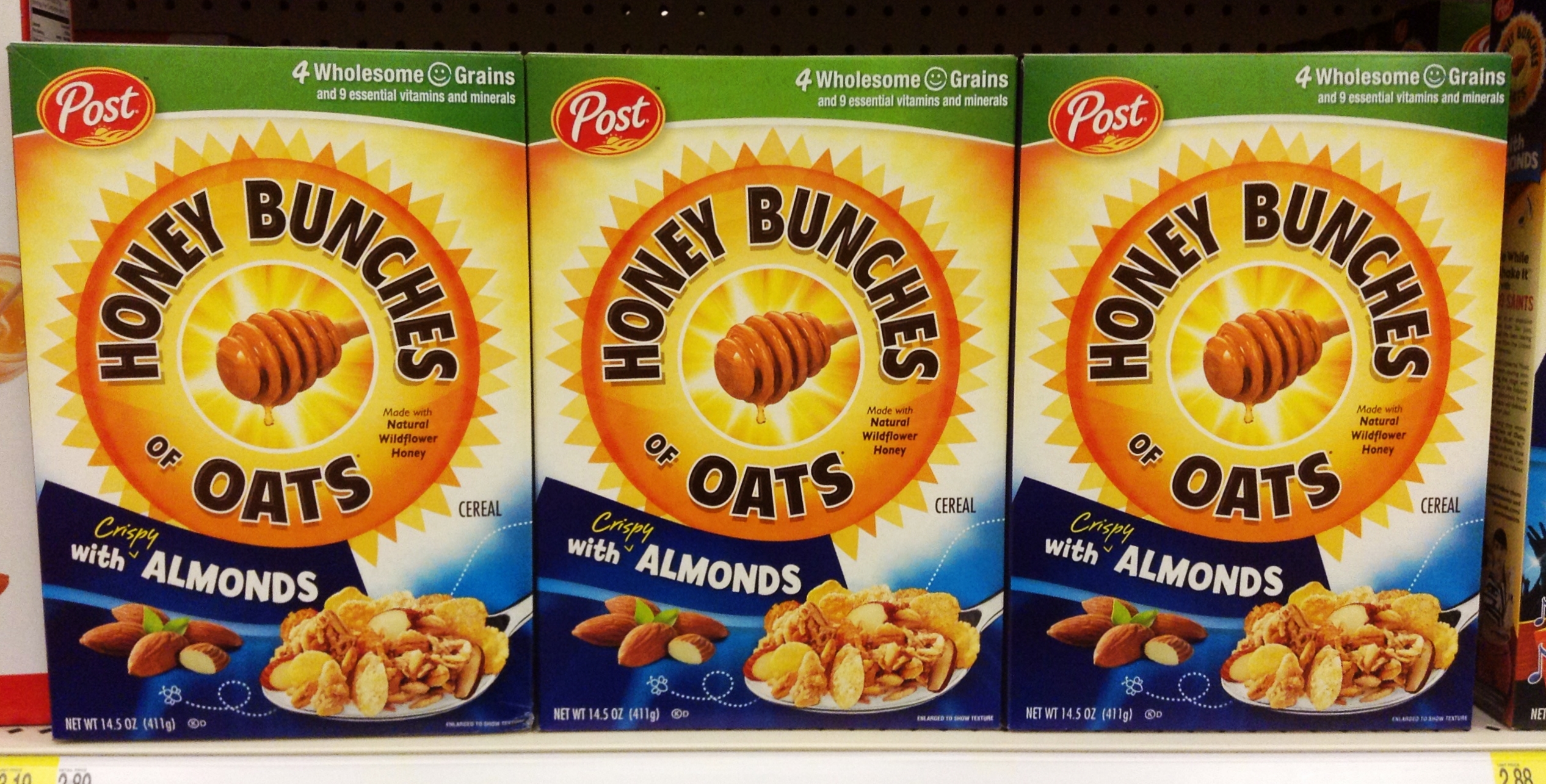 three boxes of honey bunches oats with almonds are displayed on the shelf in a store