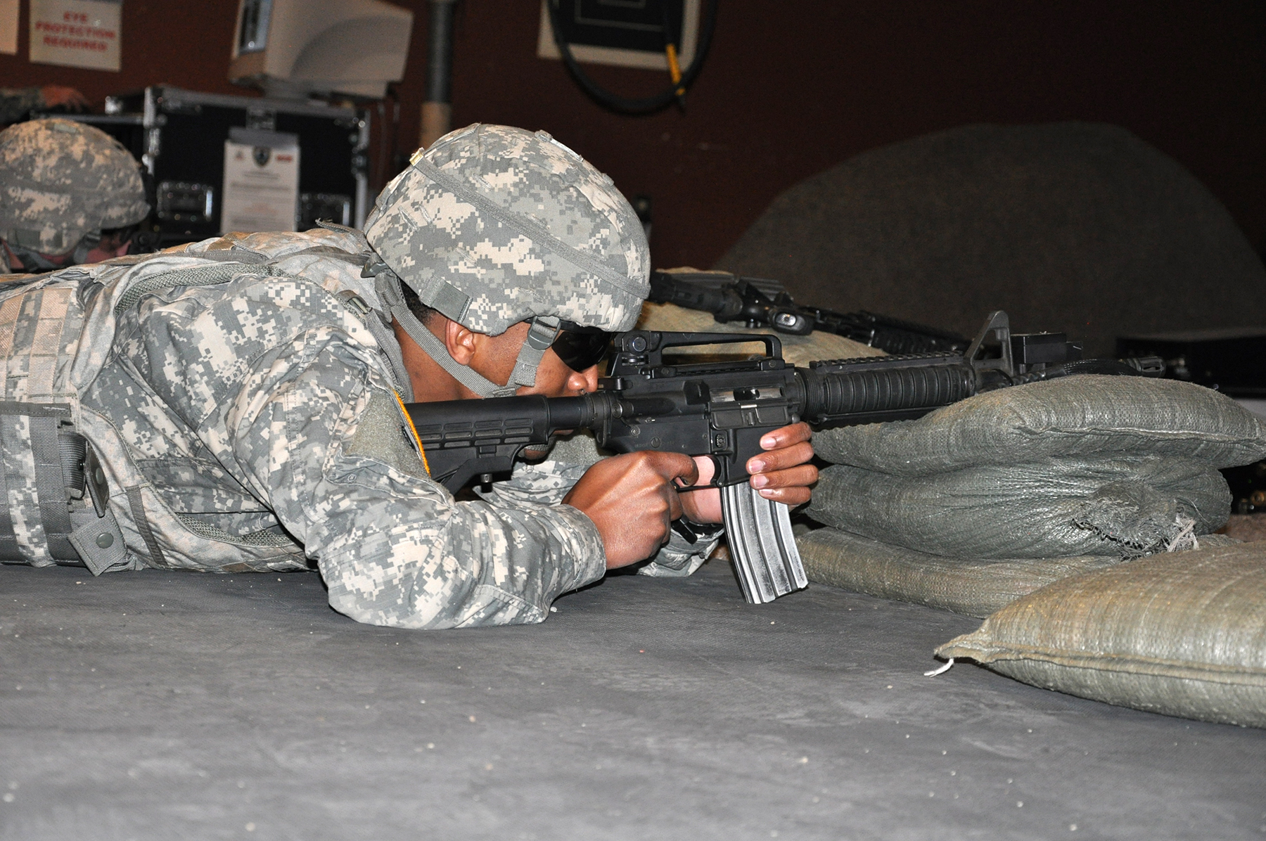 a soldier crouches down to place an akp at the base