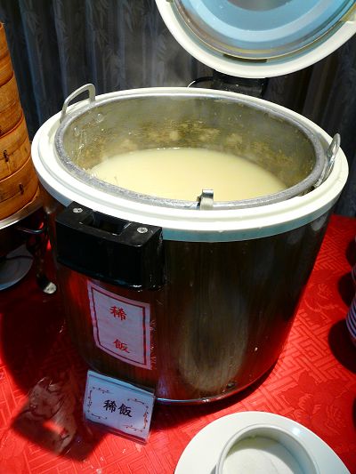 a pot of soup on a table with other foods